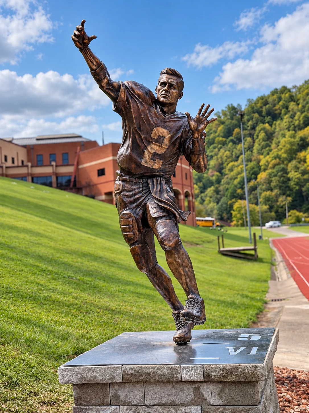 Full-height bronze monument depicting athlete Tim Couch in motion